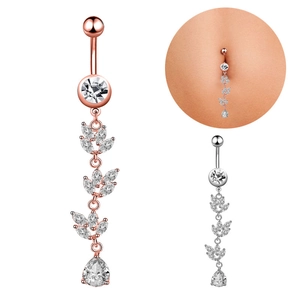 Detail of leaf-shaped belly ring with zircon inlays and teardrop pendant on white background