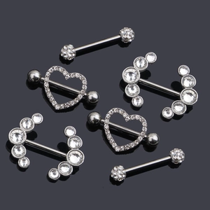 Detailed view of silver zircon nipple bars with heart and curved diamond accents
