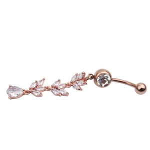 Macro shot of rose gold belly button ring with zircon leaf pendant and teardrop crystal