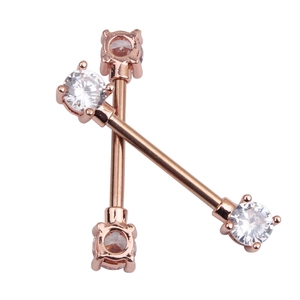Close-up of rose gold nipple rings with white zircon stones in cross layout