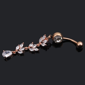 Detailed close-up of rose gold belly ring with leaf-shaped and teardrop zircon crystals