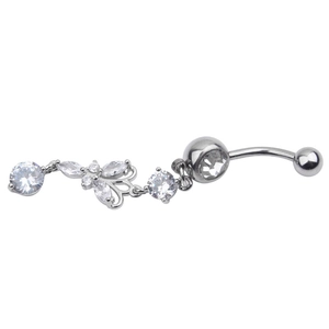 Macro detail of silver navel ring with zircon flower pendant and curved barbell design