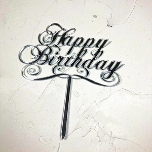 Macro detail of silver mirror acrylic Happy Birthday cake topper with artistic font