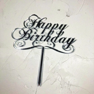 Macro detail of silver mirror acrylic Happy Birthday cake topper with artistic font