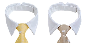 Detail of adjustable pet bow tie collar with white star print and velcro fastening strap