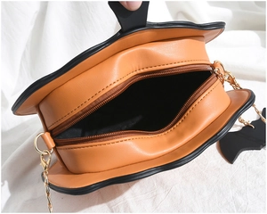 Top view of pumpkin bag with bat wings, showing internal lining and metal chain strap