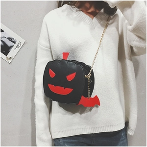 Detail of black pumpkin bag with red devil face and gold chain with bat pendant