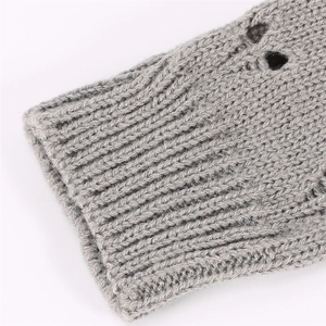 Macro view of grey knitted arm sleeves showing ribbed cuff and texture details