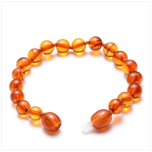 Detailed macro view of natural amber beads bracelet with a secure screw clasp closure