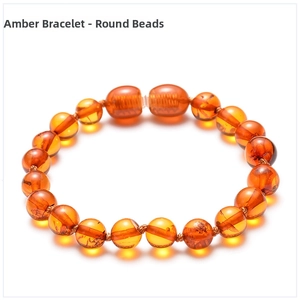 Macro detail of fire amber bracelet beads with natural sun spangles and clear textures