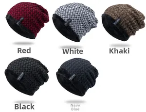 Detail showing various colors of thick knit beanies with warm fleece lining and brand tags