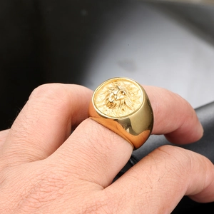 Close-up of golden lion head signet ring worn on finger with rock hip hop style