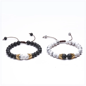 Detail of 8mm lava stone and white turquoise couple bracelets with crown charms