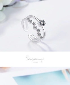 Detail view of double-layer silver star ring with brilliant zircon crystals and open band