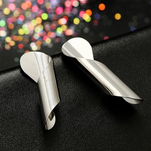 Modern irregular spiral silver earrings with a glossy metallic finish on black leather