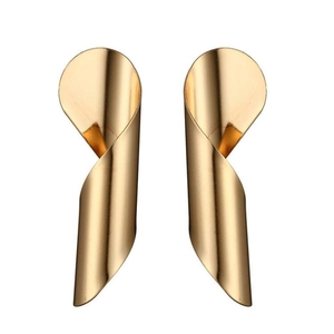 Macro detail of the golden spiral design and polished metallic finish of the earrings