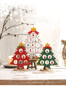 Three wooden mini Christmas trees with colorful ornaments and festive holiday decorations