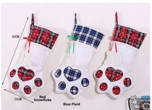 Detailed view of paw-shaped Christmas stockings in red snowflake and blue plaid patterns