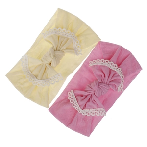 Detailed view of soft nylon baby headbands with a large bow and white lace trim.