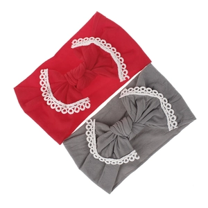 Detailed view of red and grey baby headbands with large lace-edged soft nylon bows
