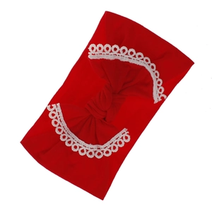 Detailed view of red soft nylon baby headband with a large white lace-edged bow