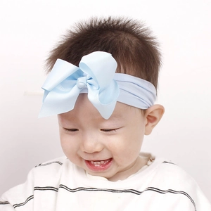 Großaufnahme eines Babys mit einem großen hellblauen Schleifenstirnband aus Nylon