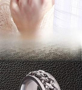 Macro shot of silver stainless steel rotating cuban link chain spinner ring for men