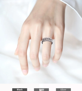 Close-up of rotatable spinner bottle opener ring with chain in black gold and silver