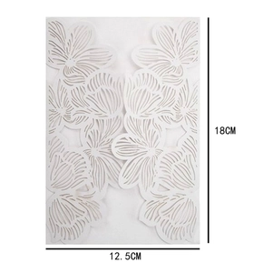 Detail of laser-cut hollow rose pattern on white wedding invitation 18cm x 12.5cm