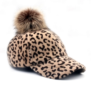 Women's leopard print baseball cap with brown faux fur pom pom for winter warmth