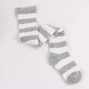 Detailed view of gray and white striped knitted tights flat laid on a white surface