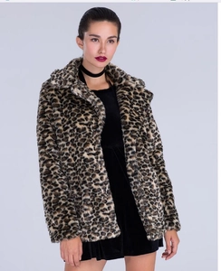 Detailed view of women's leopard print faux fur coat over a black velvet dress