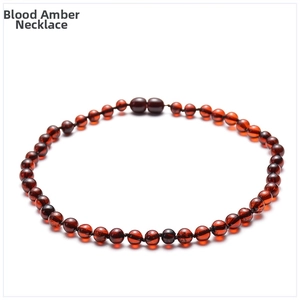 Close-up of natural Baltic blood amber necklace with translucent beads and screw clasp