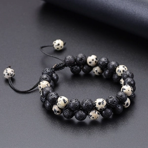 Detail of double-layer lava stone and spotted agate beads on adjustable woven bracelet