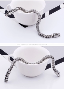 Detailed view of silver stainless steel dragon bone chain bracelet with square metal buckle