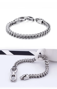 Macro view of men's stainless steel dragon bone chain bracelet with square buckle clasp