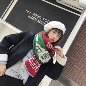 Detail of knit Christmas scarf with red and green patchwork and snowflake pattern