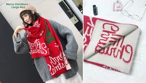 Close-up of red knitted Christmas scarf featuring white snowflakes and tree patterns