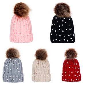 Selection of knit baby beanies in pink, black, grey, beige and red with faux fur pompoms