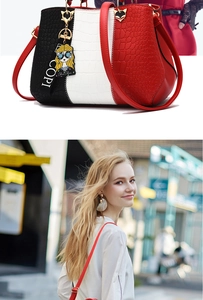 Detail view of tri-color crocodile texture tote bag with gold hardware and shoulder strap