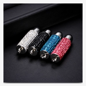 Detailed view of bullet-shaped steel pendants with crystal inlay in four colors