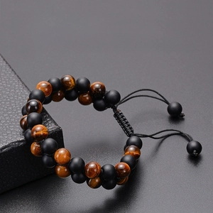 Detail of adjustable double-layer tiger eye and matte onyx beaded healing bracelet