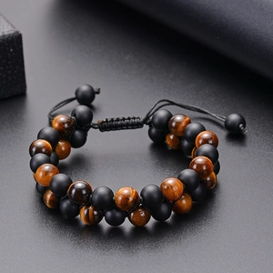 Detail of tiger eye and matte black onyx beads on adjustable double row woven bracelet