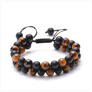 Detail of tiger eye and matte black stone double-layer beaded bracelet with braided cord