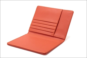 Detailed interior of orange leather passport holder with four card slots and pocket