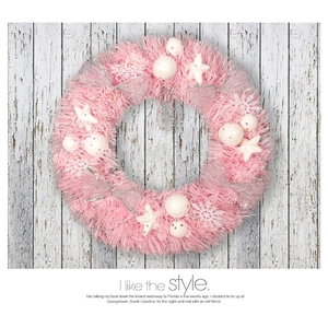 Pink Christmas wreath with white stars and silver bows on a grey wooden background