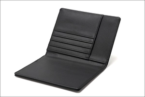 Detail view of the black leather passport wallet with internal RFID card slots and stitching