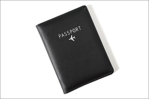 Detail of black leather passport holder with RFID blocking and embossed aircraft logo