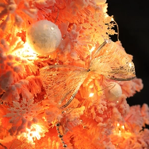 Pink flocked mini Christmas tree with LED lights, glittery bow and snowflake ornaments