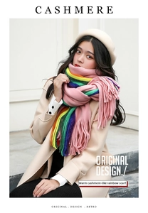 Detail of soft rainbow striped cashmere-feel scarf with long fringe tassels